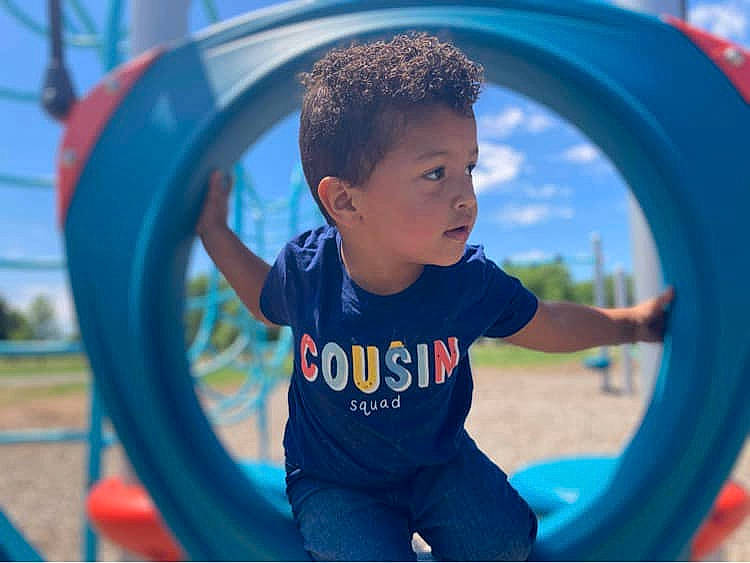 Logan joined the competition — help win amazing prizes! automotive_tire, automotive_wheel_system, baby_toddler_clothing, blue, city, fun, grass, happy, leisure, outdoor_play_equipment, person, playground, playground_slide, product, public_space, recreation, rim, t_shirt, tire, toddler