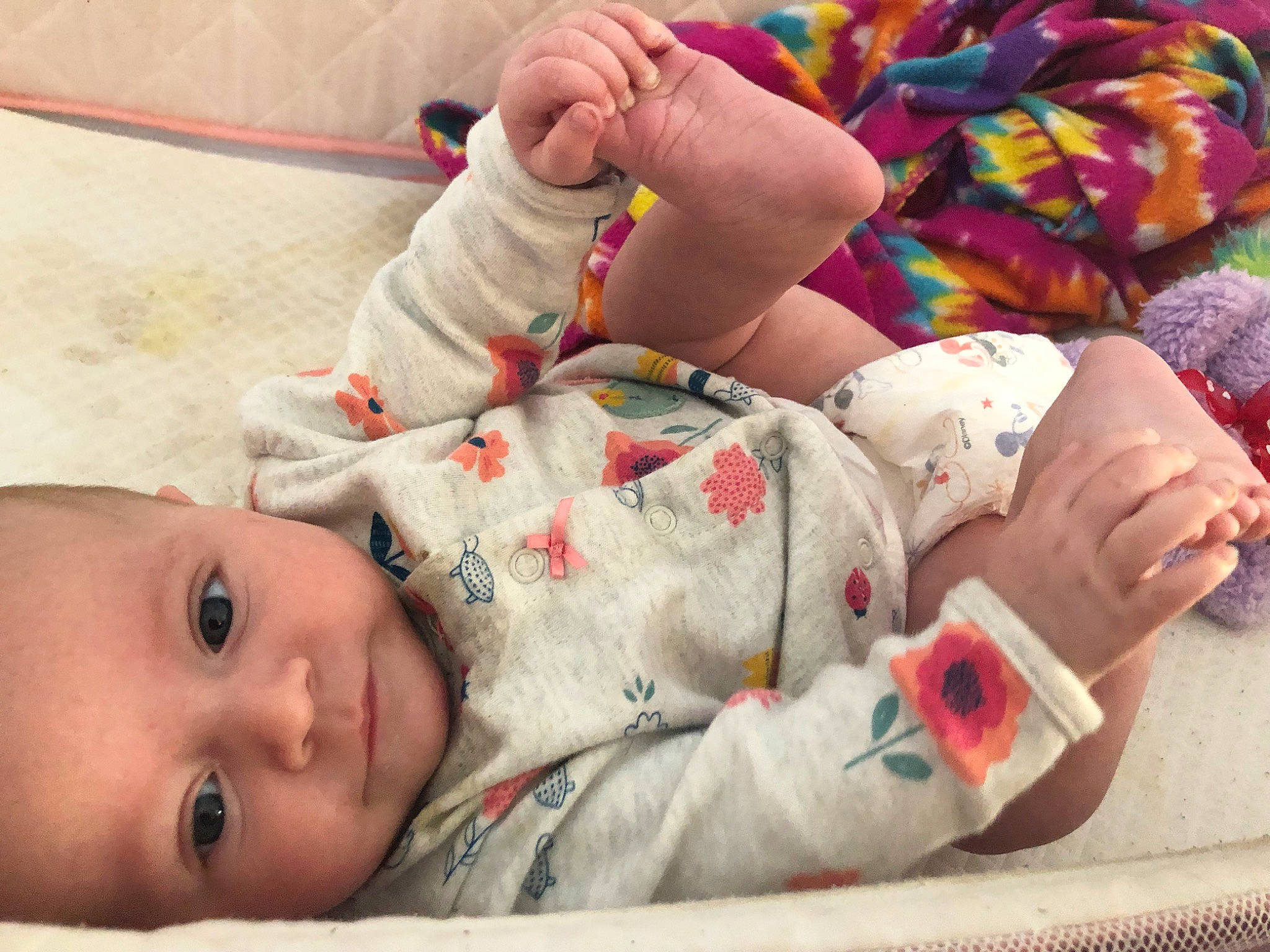 Ryalee is registered to the contest to win money with this photo: baby, baby_products, baby_toddler_clothing, carmine, cheek, child, comfort, face, facial_expression, foot, hand, human_leg, linens, mouth, nail, pattern, person, room, skin, toddler