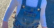 A'Moura joined the competition — help win amazing prizes! blue_bow, casual_clothing, child, cute, daylight, denim_overalls, happy, outdoor, pavement, person, playful, shadow, small_child, smiling, sneakers, standing, sunlight, toddler, white_shirt, young_child