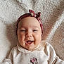baby, smiling, headband, bow, white_outfit, minnie_mouse, blanket, soft_texture, happy, infant, cute, portrait, child, clothing, face, lying_down, indoors, closeup, adorable, young_child