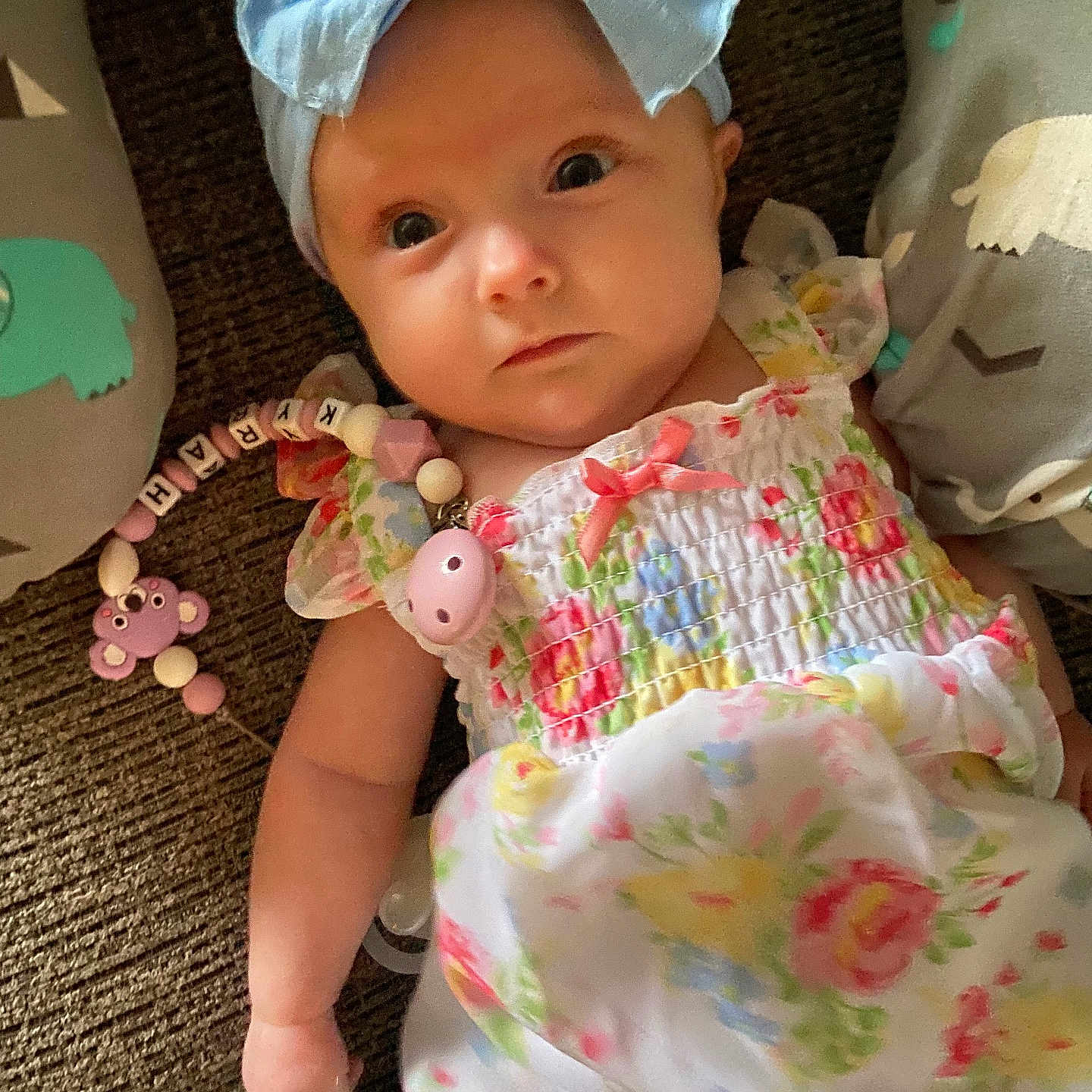 Kyrah is registered to the contest to win money with this photo: accessories, baby, bonnet, cap, clothing, couch, cushion, dress, face, furniture, hat, head, homedecor, jewelry, newborn, person, photography, portrait, sitting, toy