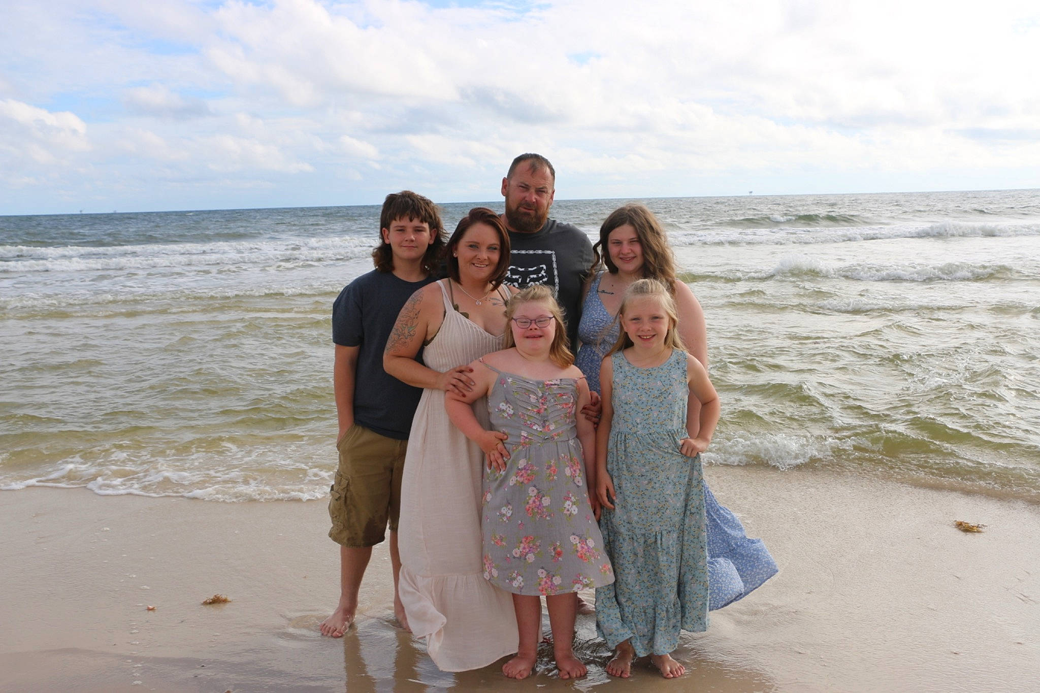 Jacklyn And Jaymi is registered to the contest to win money with this photo: beach, cloud, coastal_and_oceanic_landforms, dress, event, formal_wear, fun, gesture, happy, horizon, joy, landscape, leisure, natural_environment, people_in_nature, people_on_beach, person, sand, sky, smile