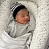 baby, newborn, sleeping, blanket, hat, striped_hat, swaddle, cushion, star_pattern, infant, peaceful, cozy, child, portrait, resting, indoor, cute, soft, comfortable, baby_bedding