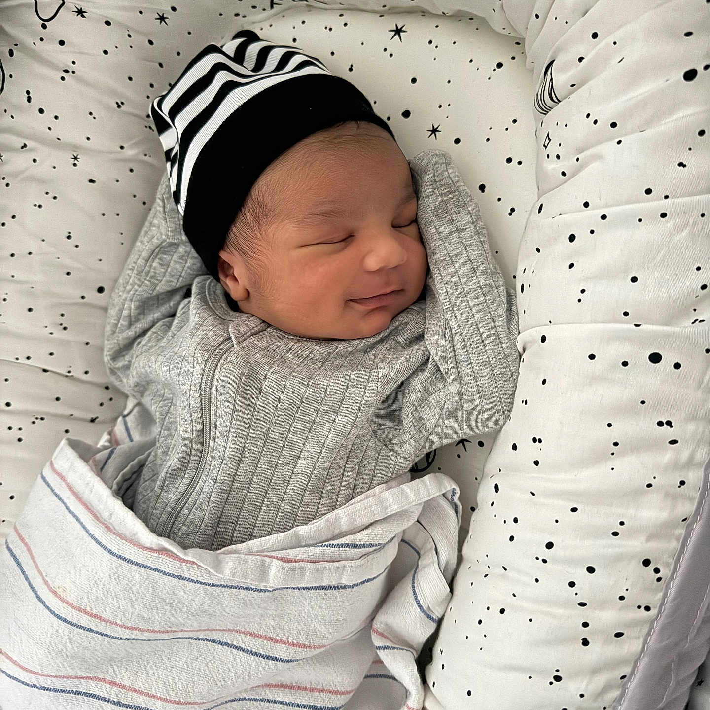 Yosiah joined the competition — help win amazing prizes! baby, newborn, sleeping, blanket, hat, striped_hat, swaddle, cushion, star_pattern, infant, peaceful, cozy, child, portrait, resting, indoor, cute, soft, comfortable, baby_bedding