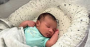 Yosiah is registered to the contest to win money with this photo: baby, baby_nest, blanket, child, cozy, cute, face, indoors, infant, mesh_canopy, newborn, onesie, patterned, peaceful, portrait, resting, sleep, sleeping, soft, star