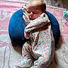 baby, blanket, blue_cushion, child, comfort, cozy, cute, fabric, floral_onesie, head, indoors, infant, peaceful, pink_blanket, portrait, resting, sleeping, small_person, soft_texture, toddler