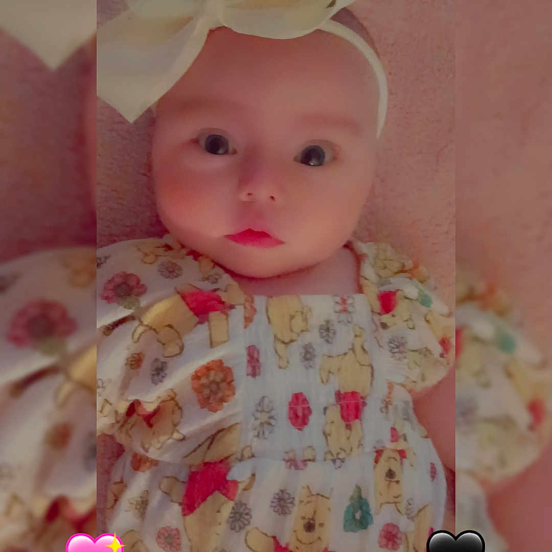 Nova Bowling joined the competition — help win amazing prizes! baby, infant, headband, bow, dress, winnie_the_pooh, patterned_clothing, pink_background, heart_emoji, black_heart, pink_heart, cute, child, portrait, closeup, soft_lighting, indoors, face, wide_eyes, adorable