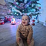 Lynaé participe au concours pour gagner de l'argent avec cette photo : baby, child, christmas_tree, festive, floor, happy, holiday_decorations, indoor, lights, ornaments, pigtails, pink_ornaments, santa_figure, sitting, smiling, toddler, toy_train, white_ornaments, winter_clothing, wooden_floor