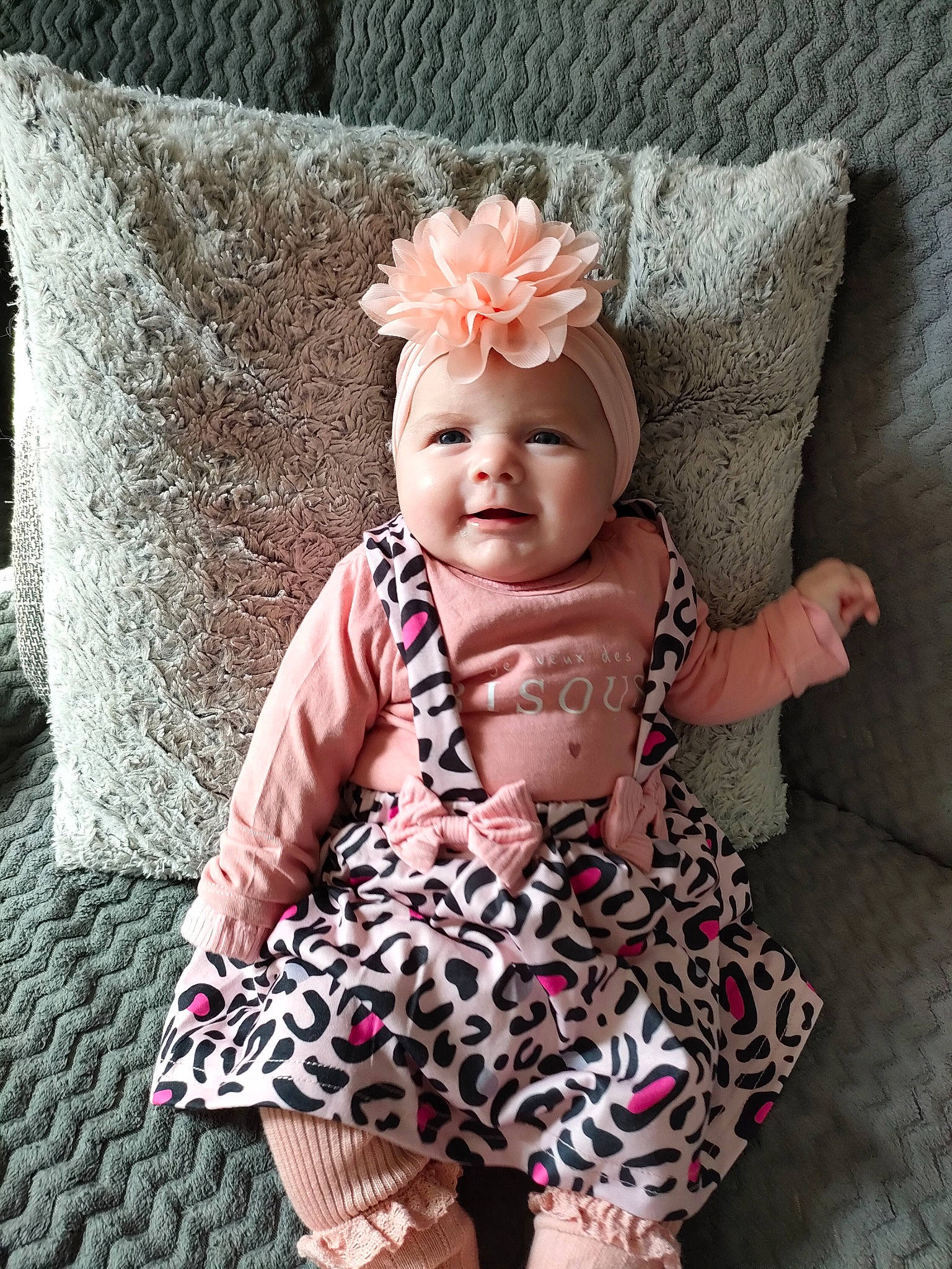 Emma participe au concours pour gagner de l'argent avec cette photo : baby, baby_toddler_clothing, cap, child, cool, costume_hat, fashion_accessory, happy, headgear, headpiece, headwear, jewellery, magenta, pattern, person, pink, sitting, skin, sleeve, smile