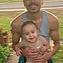 man, child, smiling, outdoor, sunset, garden, grass, road, holding, happy, tank_top, shorts, baby, person, family, nature, blur, casual_clothing, daytime, toddler