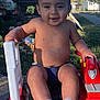 toddler, child, outdoor, toy, fire_truck, smile, bare_chest, socks, diaper, happy, sunlight, grass, play, young_child, vehicle, casual, daytime, cute, fun, park