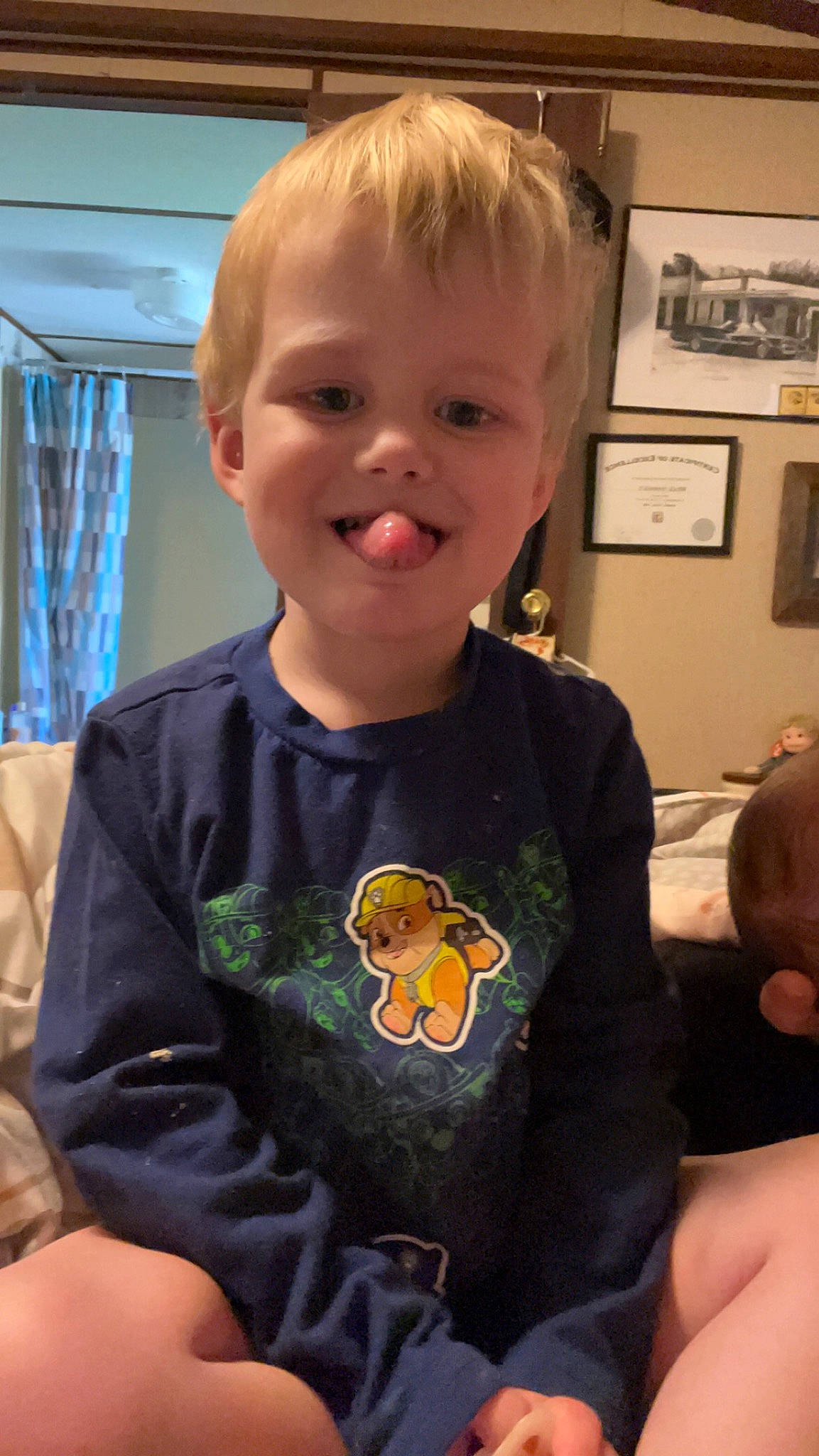 Oliver is registered to the contest to win money with this photo: baby_toddler_clothing, cheek, child, chin, cool, curtain, electric_blue, finger, fun, hairstyle, happy, head, joy, mouth, nose, person, picture_frame, sleeve, smile, t_shirt