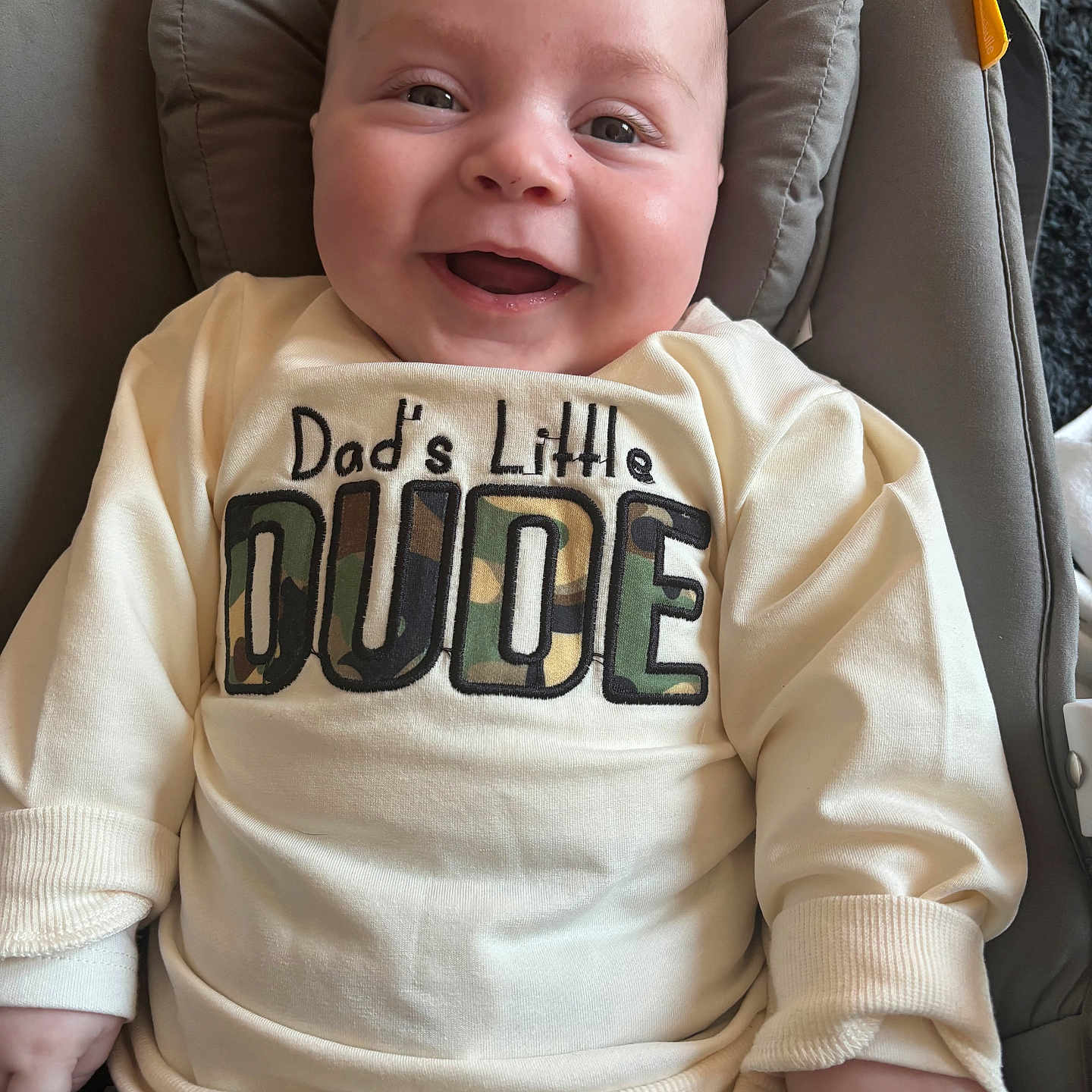 Arran is registered to the contest to win money with this photo: baby, babylaughing, clothing, coat, cushion, face, happy, head, homedecor, jacket, knitwear, laughing, pants, person, photography, portrait, shirt, smile, sweater, t_shirt