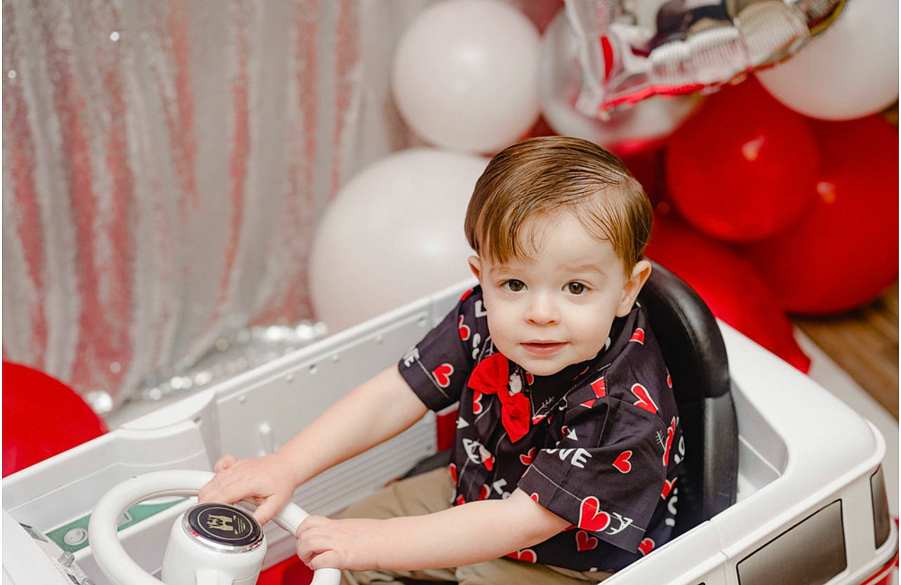 Kennedy joined the competition — help win amazing prizes! automotive_design, baby, balloon, child, event, fun, happy, leisure, machine, party, party_supply, person, play, red, room, sitting, smile, t_shirt, toddler, toy