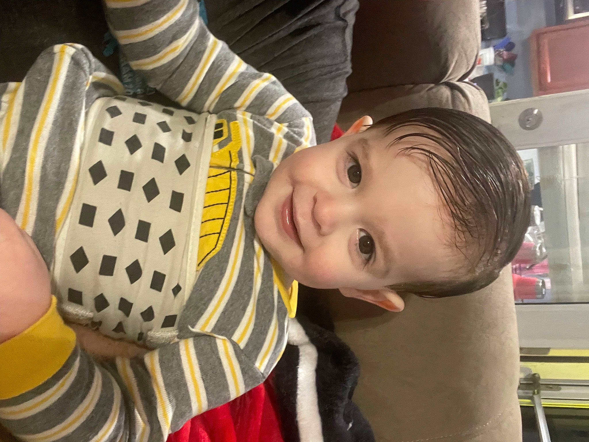 Kennedy is registered to the contest to win money with this photo: baby_toddler_clothing, child, eye, facial_expression, finger, fun, hairstyle, happy, hat, joy, leisure, mammal, mouth, nose, pattern, people, person, sitting, smile, thigh