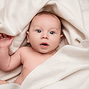 David-John is registered to the contest to win money with this photo: baby, infant, face, skin, blanket, cream, soft, cute, expression, eyes, mouth, hand, newborn, portrait, child, indoors, warm, comfort, cozy, sleepwear