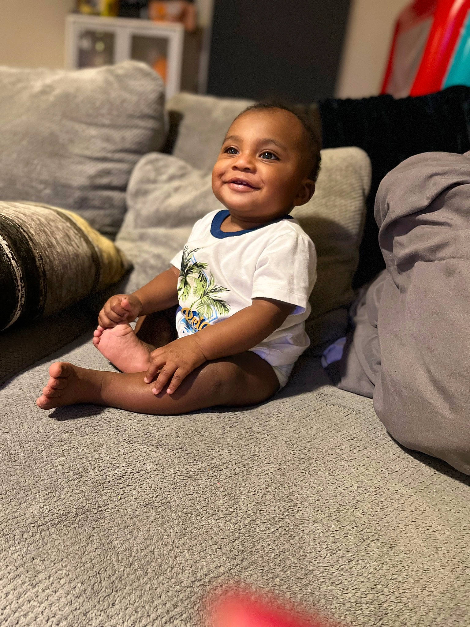 Messiah joined the competition — help win amazing prizes! baby, baby_toddler_clothing, cheek, child, comfort, couch, facial_expression, flash_photography, floor, flooring, fun, hairstyle, happy, human_leg, joy, living_room, person, sitting, smile, standing