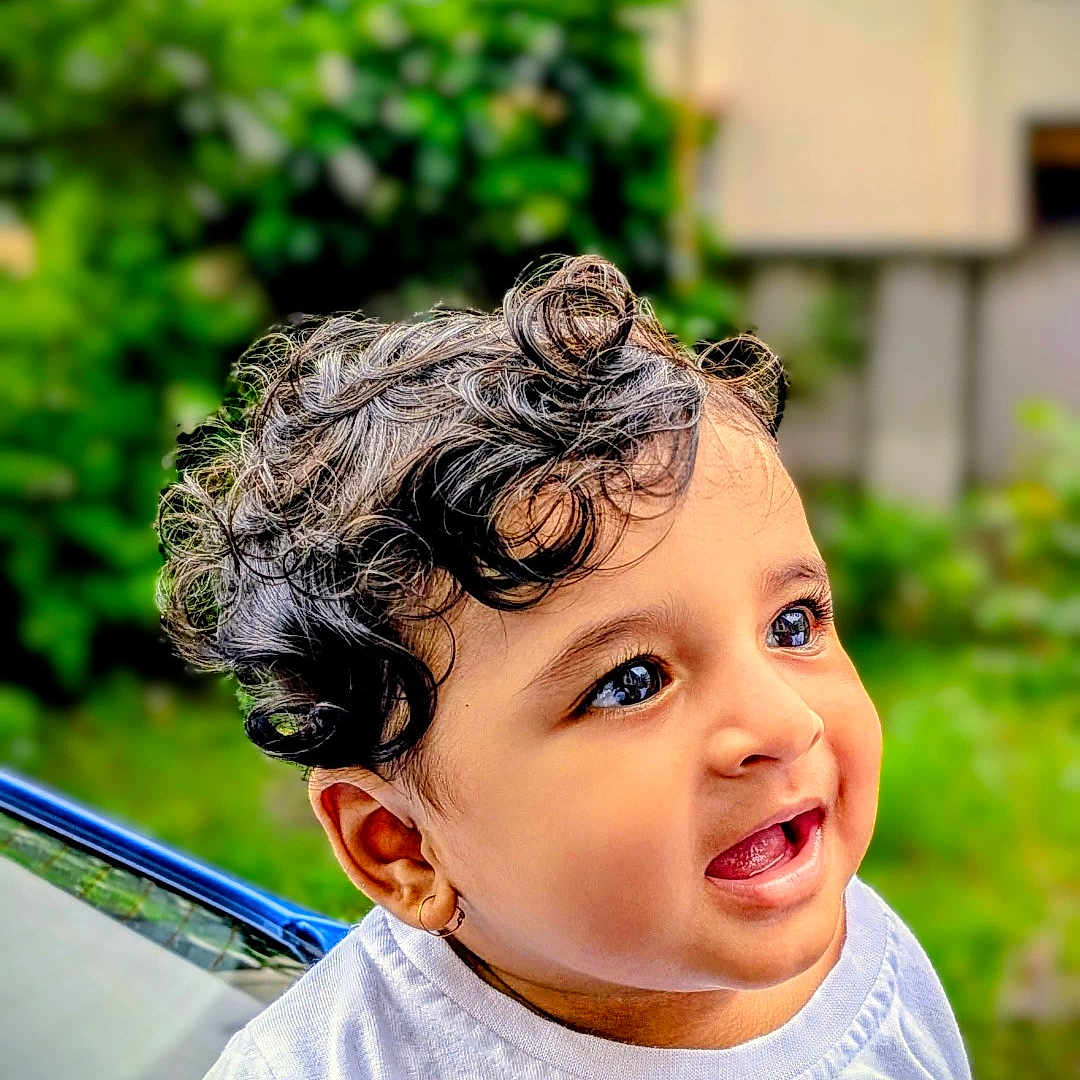 Parv is registered to the contest to win money with this photo: baby, background_blur, child, curly_hair, cute, daylight, expression, face, greenery, hand, happy, indian_flag, nature, outdoor, person, portrait, skin, smiling, toddler, white_shirt