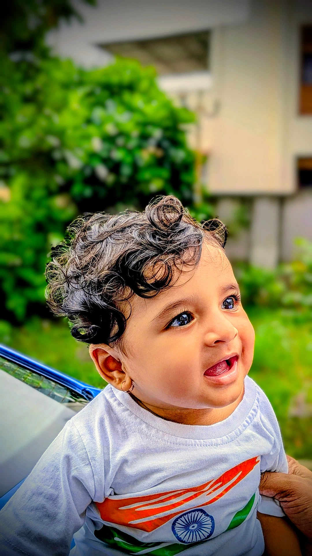 Parv is registered to the contest to win money with this photo: baby, background_blur, child, curly_hair, cute, daylight, expression, face, greenery, hand, happy, indian_flag, nature, outdoor, person, portrait, skin, smiling, toddler, white_shirt