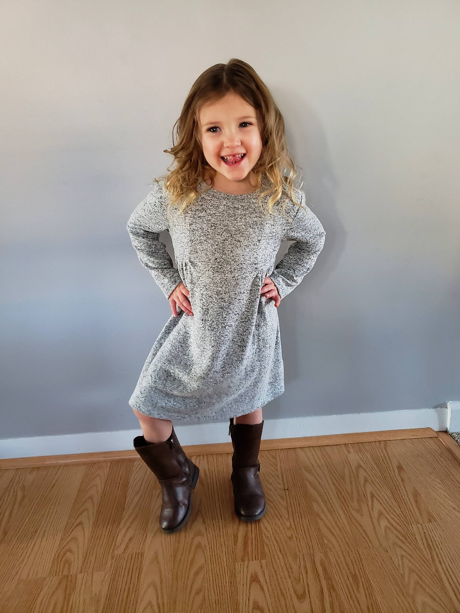 Mya is registered to the contest to win money with this photo: boot, child, child_model, clothing, dress, floor, footwear, joint, joy, knee, leg, leggings, long_hair, outerwear, pattern, person, shoe, sleeve, standing, tights