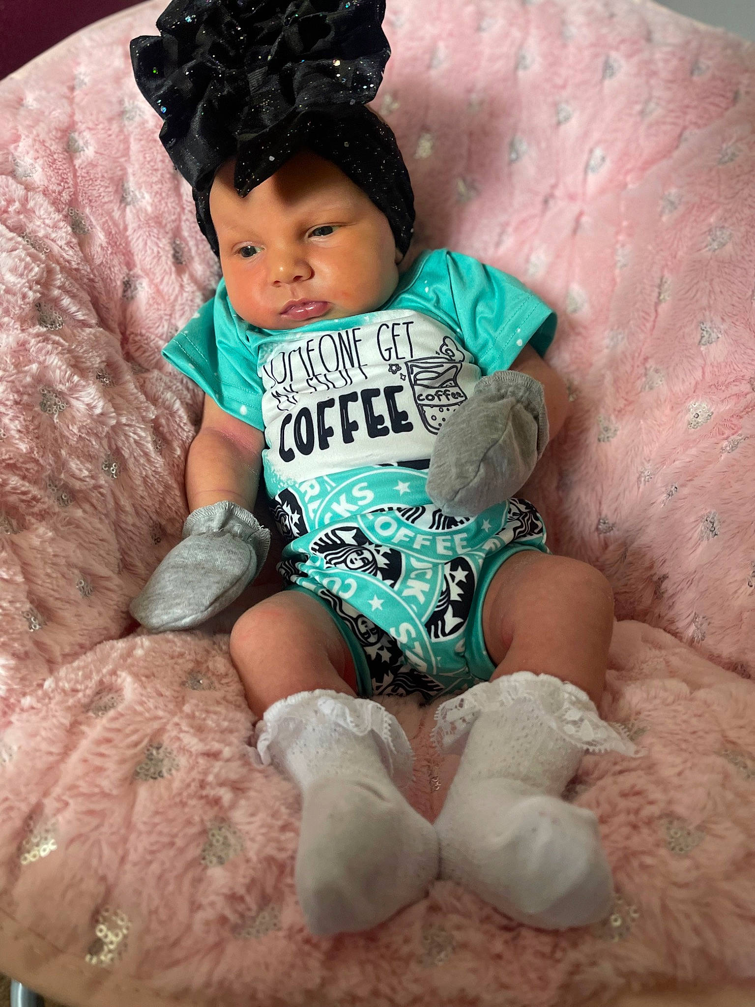 Blair is registered to the contest to win money with this photo: aqua, baby, baby_toddler_clothing, cap, child, costume_hat, eye, fashion_accessory, happy, hat, head, headgear, human_leg, person, pink, sitting, sleeve, sock, textile, thigh