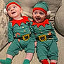 baby, infant, toddler, child, elf_costume, holiday_outfit, green_hat, red_trim, couch, beige_couch, smiling, happy, cute, festive, holiday, socks, green_socks, red_socks, two_babies, indoor