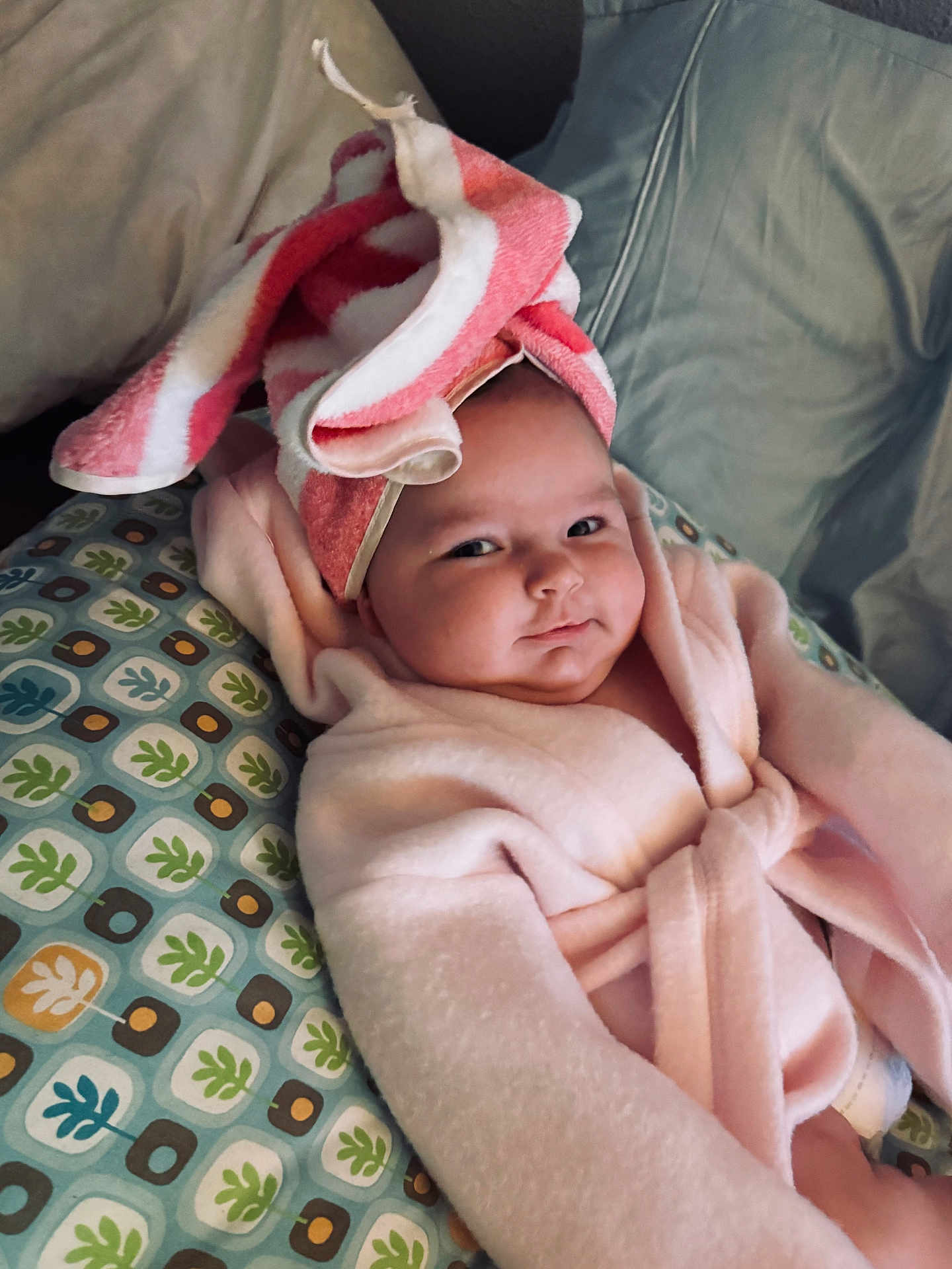 Ariya is registered to the contest to win money with this photo: baby, child, towel, bathrobe, pillow, pattern, face, headwear, indoor, cute, infant, soft, comfort, relaxing, expression, portrait, person, smile, skin, cozy