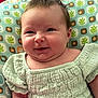 baby, infant, smile, face, clothing, cushion, pattern, green, child, cute, portrait, happy, skin, head, person, young, sitting, expression, indoors, texture