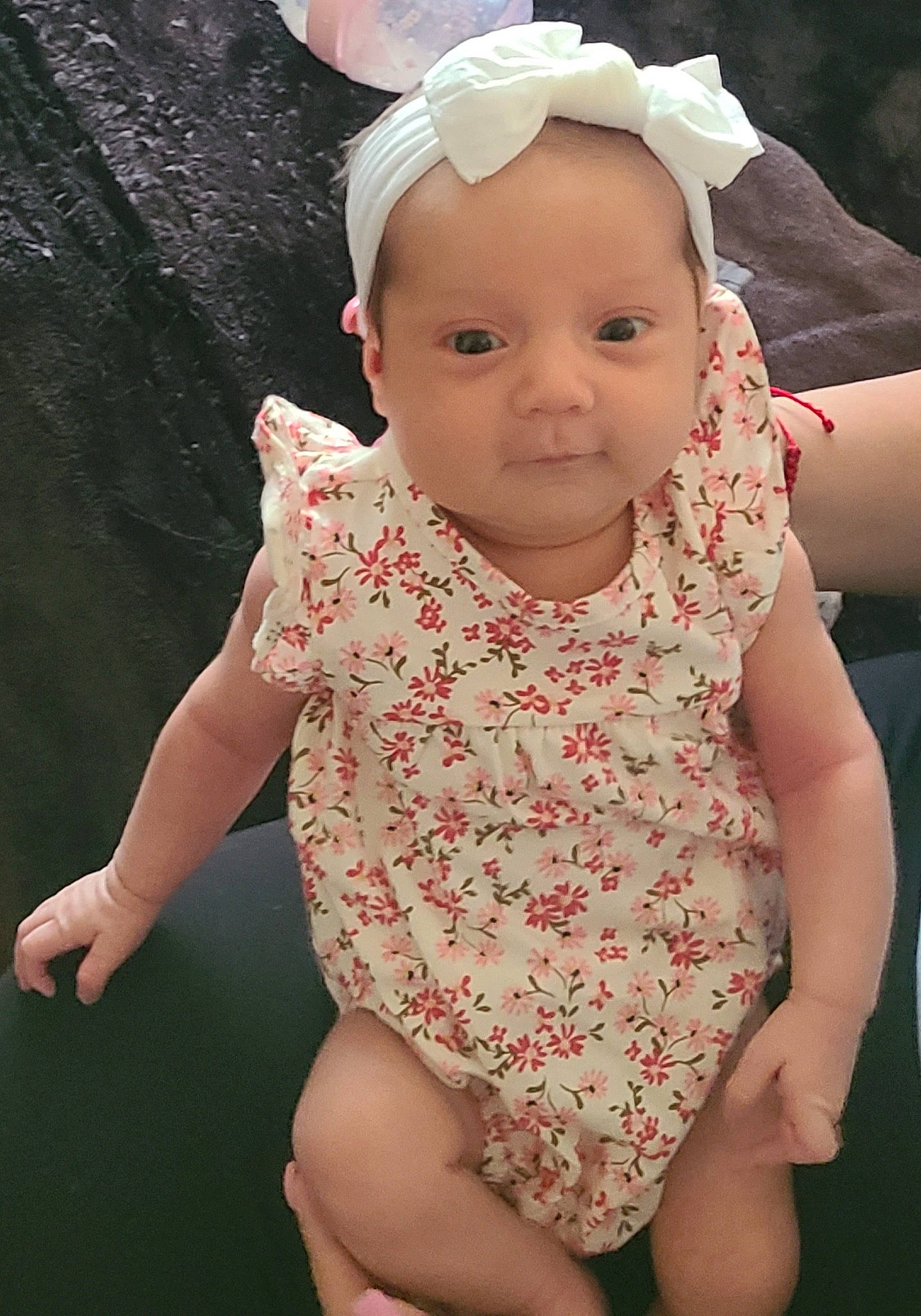 Maria is registered to the contest to win money with this photo: baby_toddler_clothing, cheek, chin, eye, eyelash, face, facial_expression, finger, gesture, happy, human_body, iris, lip, mouth, neck, person, pink, skin, sleeve, thumb