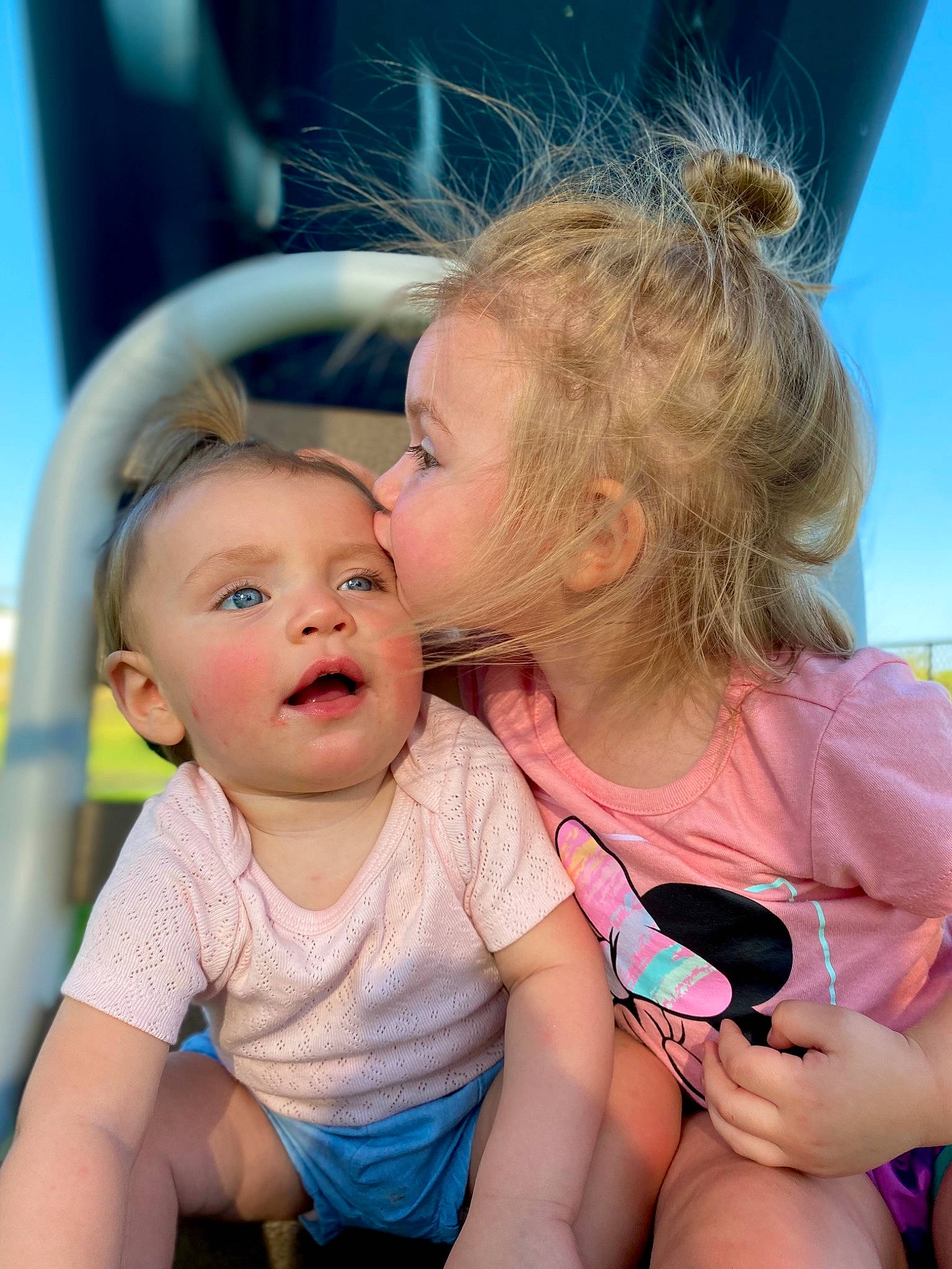 Norah is registered to the contest to win money with this photo: baby_toddler_clothing, blue, cool, facial_expression, finger, fun, gesture, happy, interaction, iris, kiss, lip, mouth, nose, organ, person, photograph, shoulder, skin, sky