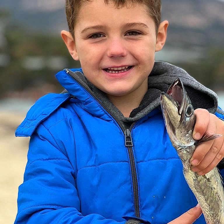 Hendrix joined the competition — help win amazing prizes! animal, bodypart, boy, child, clothing, coat, face, finger, fish, hand, happy, head, jacket, male, outdoors, person, photography, portrait, sealife, smile