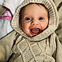 baby, child, smiling, hoodie, knitted, cozy, blue_eyes, happy, portrait, closeup, cute, infant, warm_clothing, blanket, indoors, soft_texture, person, toddler, face, expression