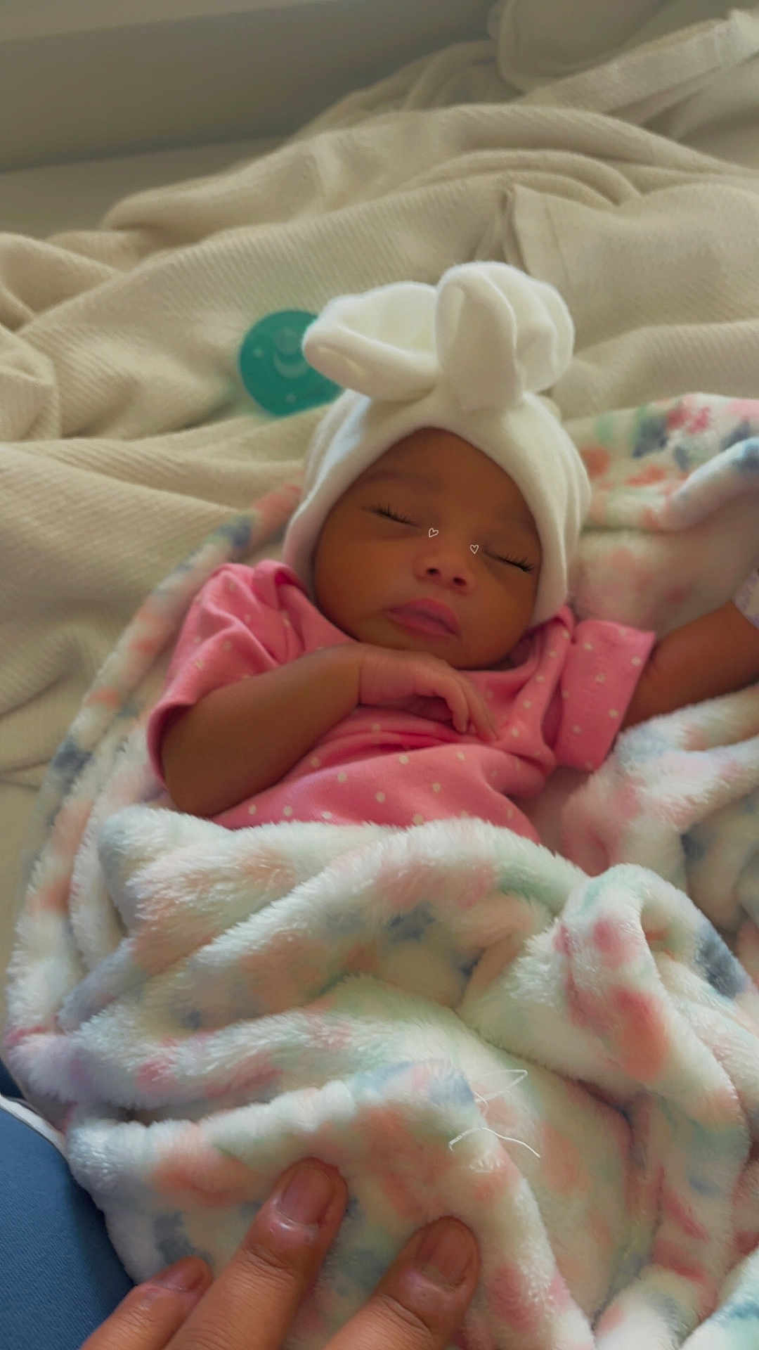 Celeste is registered to the contest to win money with this photo: baby, sleeping, blanket, pink_clothing, white_hat, bunny_ears, hand, soft_texture, pastel_colors, infant, cozy, resting, newborn, cute, indoor, warm, peaceful, child, human, portrait