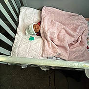 Celeste joined the competition — help win amazing prizes! newborn, baby, crib, blanket, pacifier, sleeping, hat, nursery, soft_texture, pink, white, infant, rest, cozy, child, person, bed, indoors, furniture, comfort