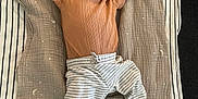 Lincoln is registered to the contest to win money with this photo: baby, sleeping, blanket, striped_pants, brown_shirt, infant, cozy, soft_texture, peaceful, indoors, child, cute, resting, relaxed, floor, striped_blanket, toddler, skin, head, foot