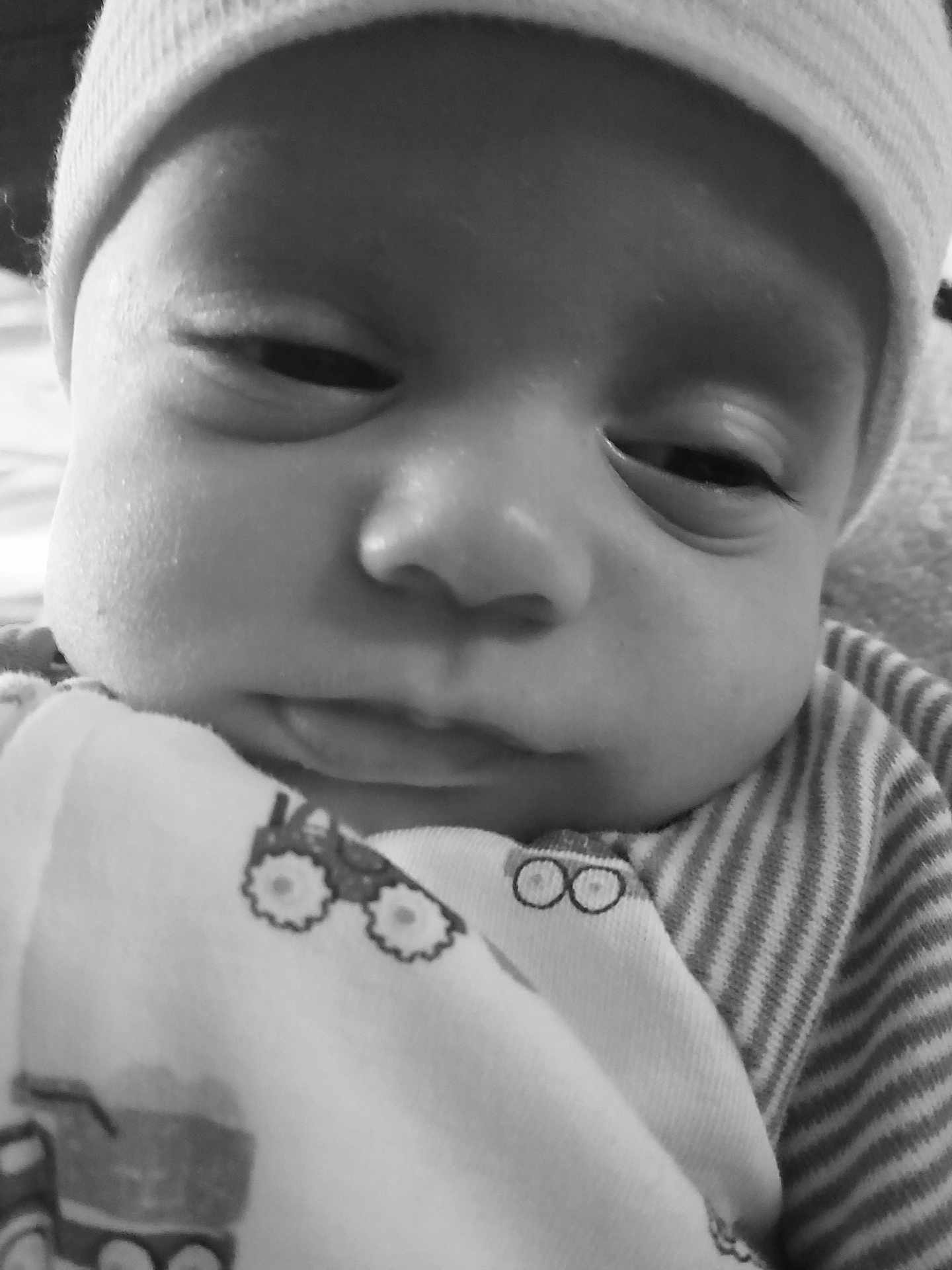 Matteo joined the competition — help win amazing prizes! baby, face, closeup, black_and_white, hat, sleepy, infant, clothing, striped, soft, peaceful, portrait, child, cute, expression, newborn, indoors, person, headwear, cozy