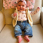 Leighton Shaw joined the competition — help win amazing prizes! baby, child, smiling, headband, bow, knitted_blanket, armchair, denim_jeans, vest, long_sleeve_shirt, barefoot, indoor, cute, happy, portrait, infant, seated, cozy, warm_colors, comfortable