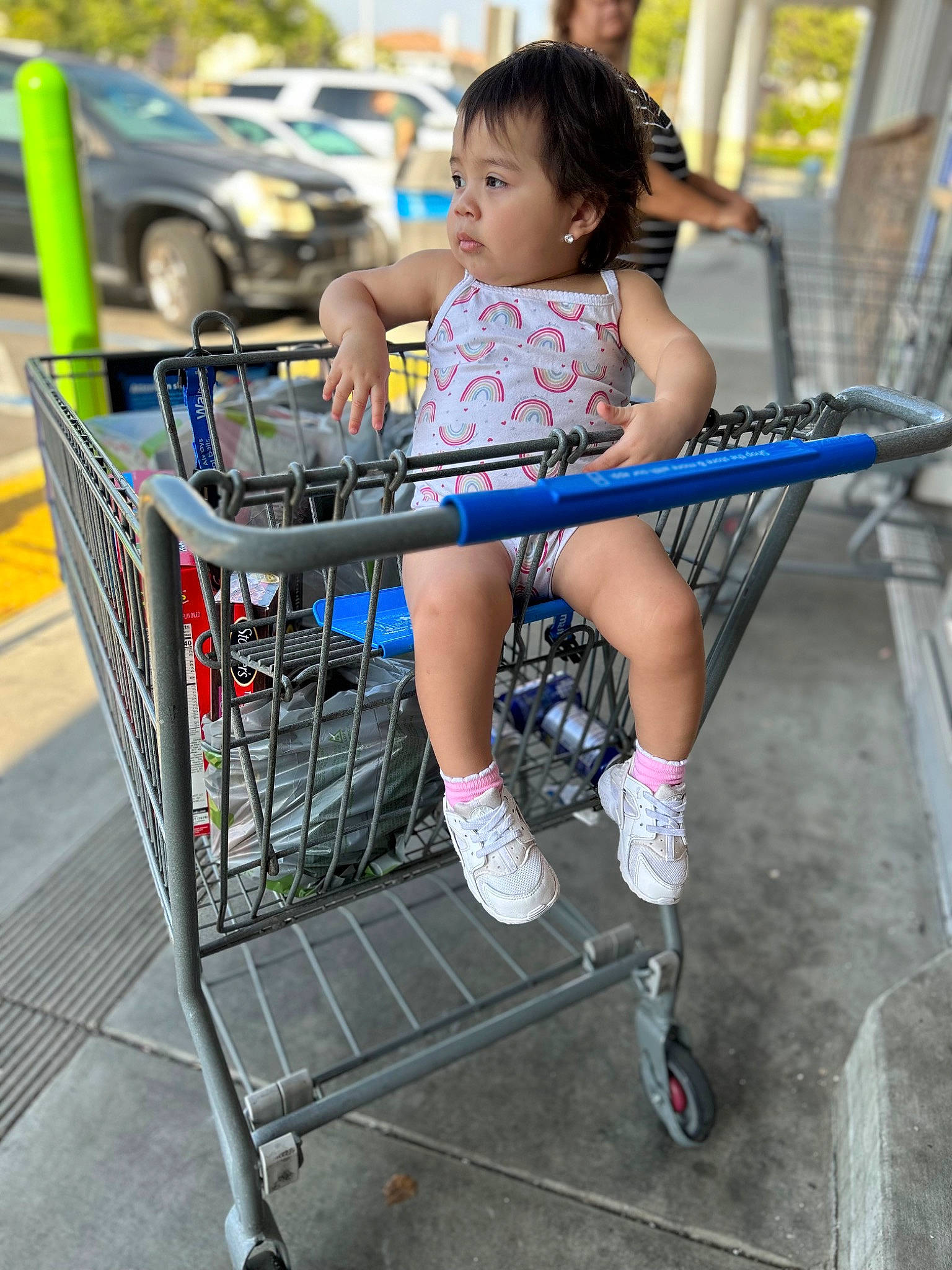 Melanie joined the competition — help win amazing prizes! car, child, city, clothing, electric_blue, fun, human_leg, human_settlement, knee, leisure, person, recreation, sandal, shopping_cart, shorts, thigh, tire, toddler, tree, vehicle