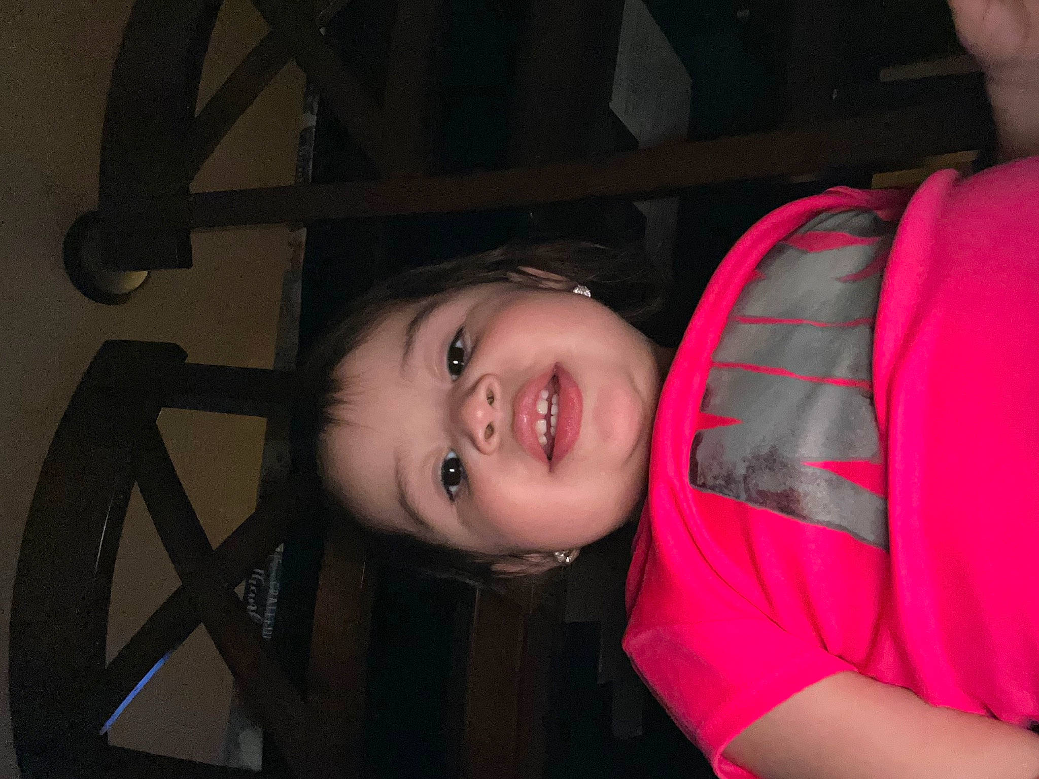 Melanie is registered to the contest to win money with this photo: baby_toddler_clothing, cheek, child, darkness, elbow, eyelash, flash_photography, fun, happy, mouth, neck, nose, person, portrait_photography, sleeve, smile, t_shirt, toddler, wood