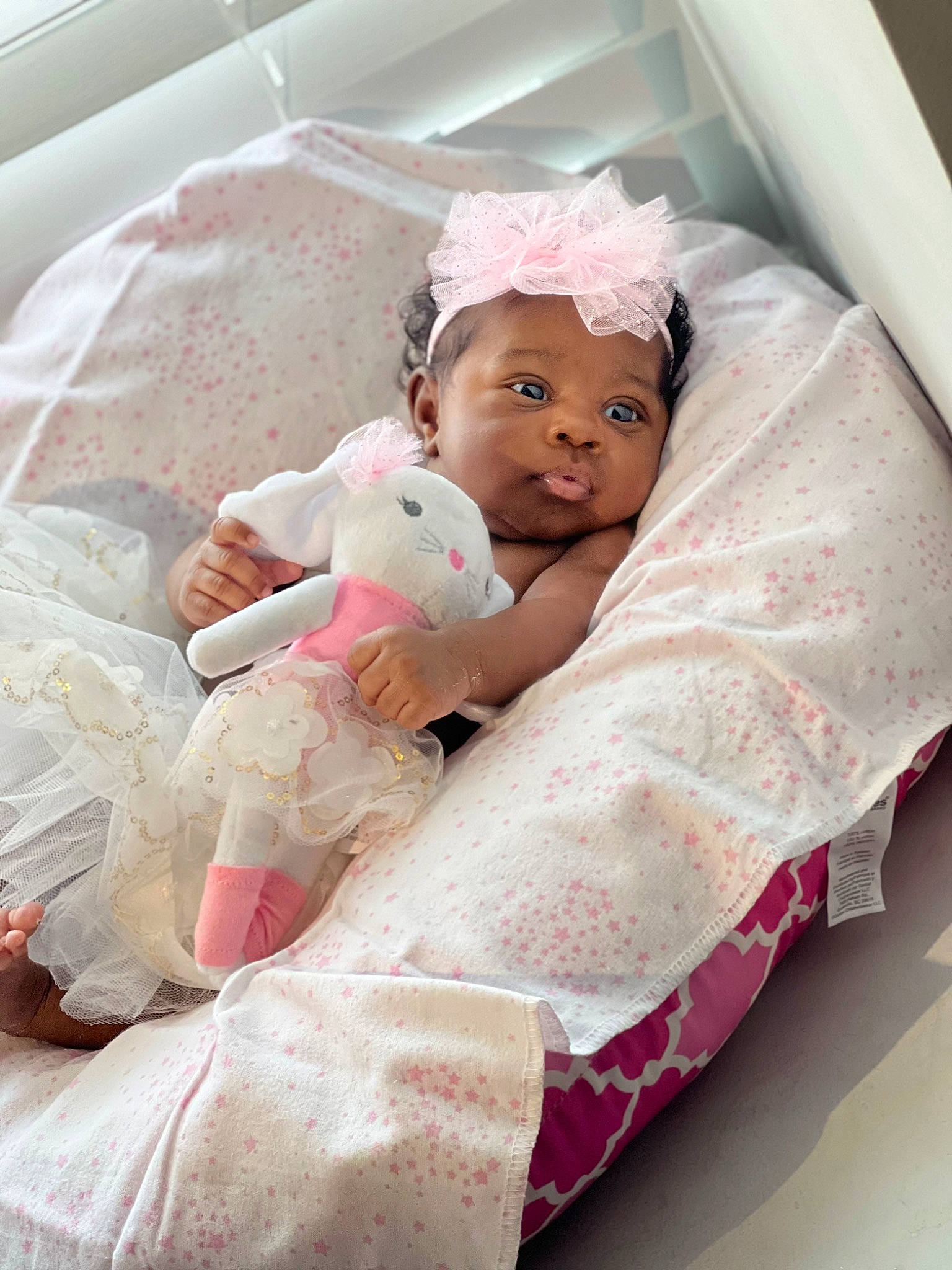 E'Layah joined the competition — help win amazing prizes! baby, baby_products, baby_safety, baby_sleeping, baby_toddler_clothing, bedding, bedtime, child, comfort, event, happy, headwear, linens, magenta, person, pink, room, sitting, skin, teddy_bear