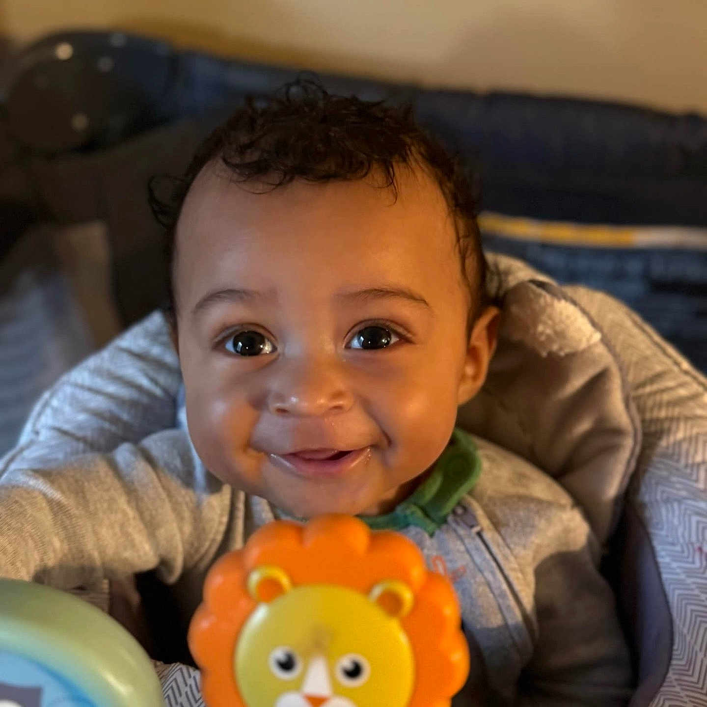 Latrell is registered to the contest to win money with this photo: baby, babylaughing, biting, curlyhair, dimples, face, hair, happy, head, person, photography, portrait, sitting, smile, toy
