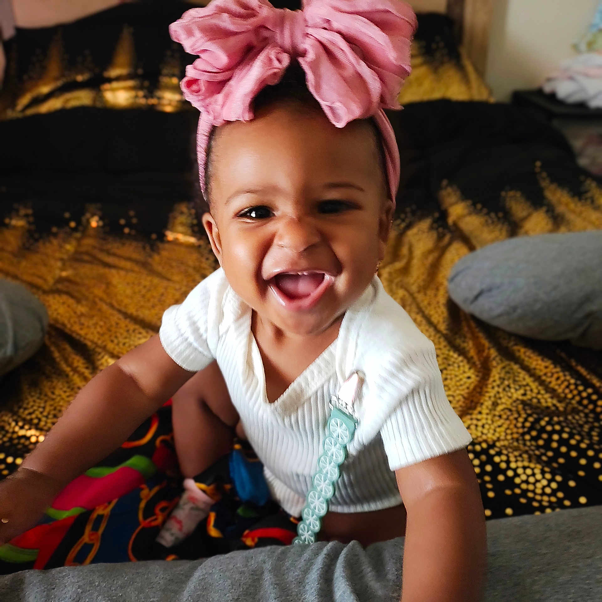 A'Livia is registered to the contest to win money with this photo: accessories, baby, babylaughing, clothing, couch, cushion, dress, face, furniture, happy, head, homedecor, indoors, jewelry, laughing, necklace, person, photography, portrait, smile
