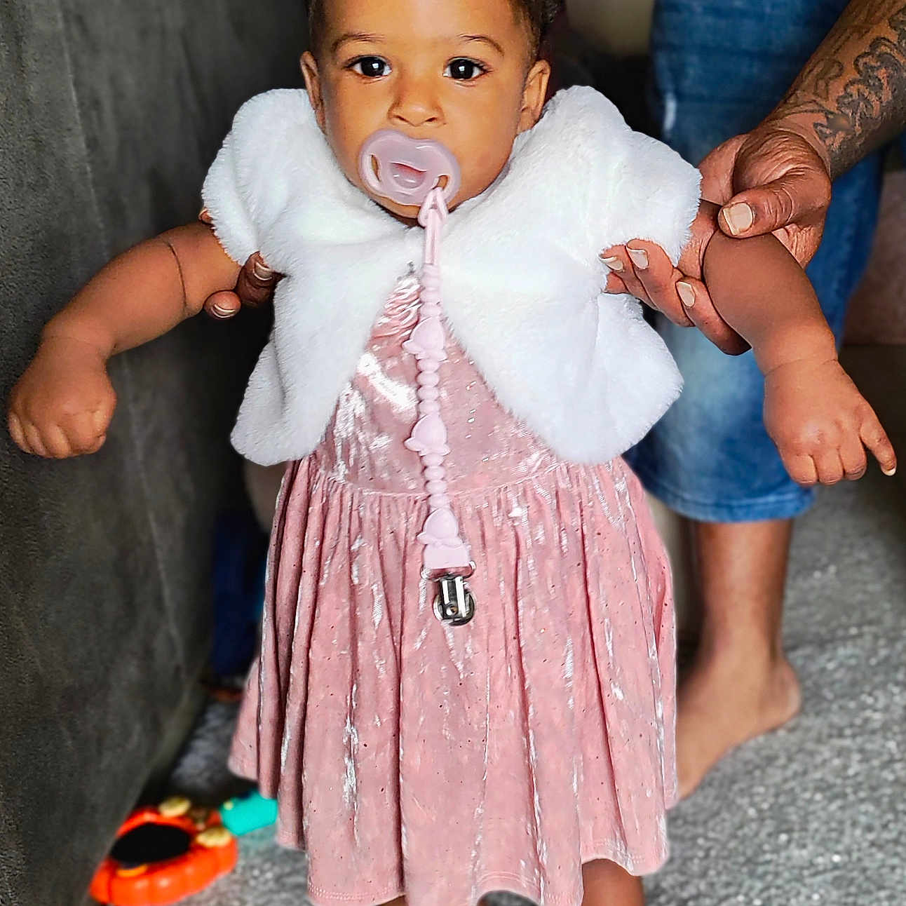 A'Livia is registered to the contest to win money with this photo: accessories, baby, bodypart, clothing, couch, dress, face, finger, footwear, furniture, hand, head, jewelry, person, photography, portrait, ring, sandal, sitting, sleeve