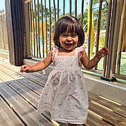 Lilas participe au concours pour gagner de l'argent avec cette photo : toddler, child, smiling, dress, barefoot, wooden_floor, outdoor, sunlight, railing, happy, girl, daylight, nature, person, playground, summer, cute, young_child, portrait, walking