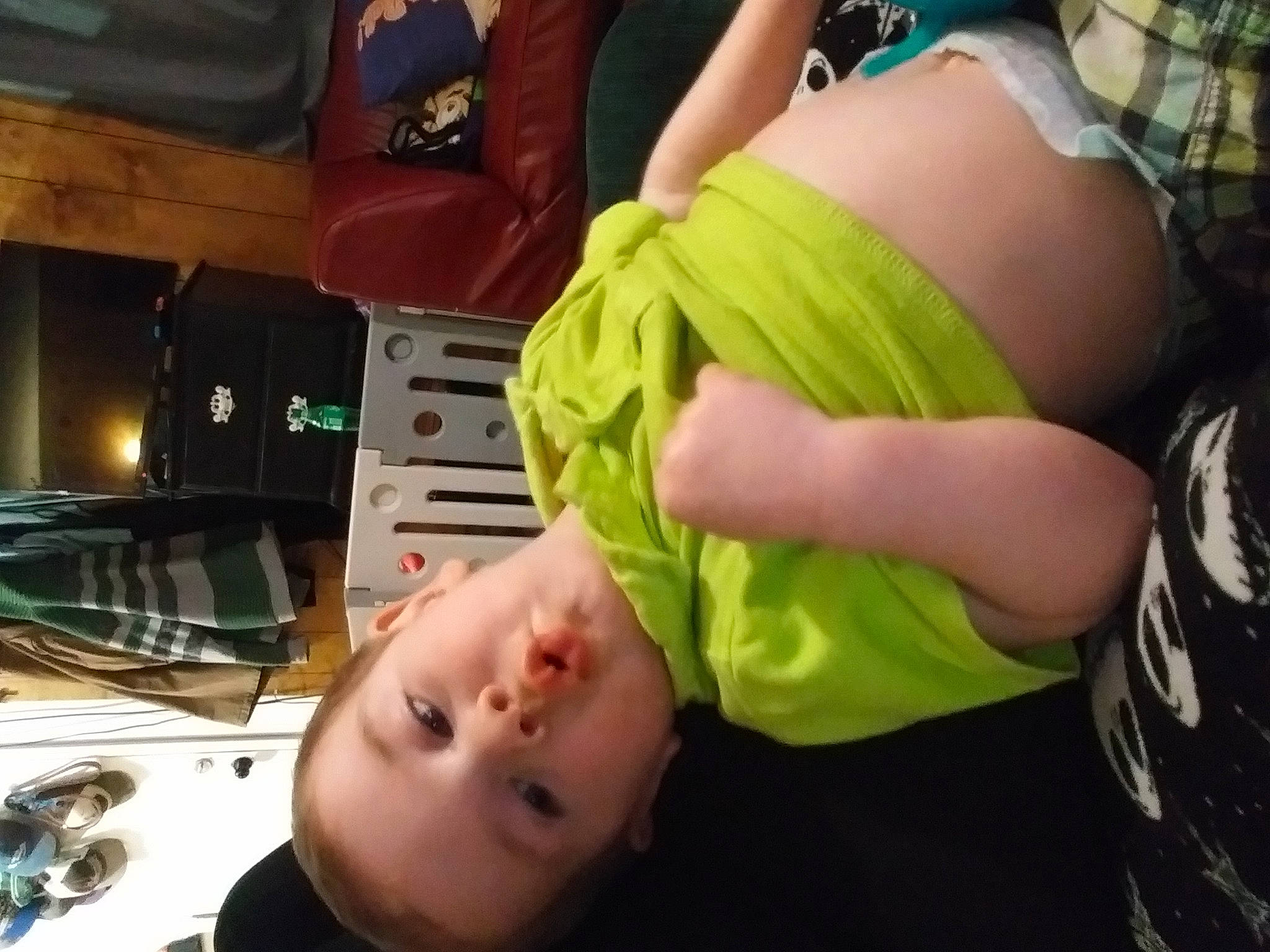 Ashton is registered to the contest to win money with this photo: abdomen, chest, child, elbow, finger, foot, fun, gesture, grass, human_leg, knee, mammal, mouth, person, sitting, t_shirt, thigh, thumb, toddler, tree