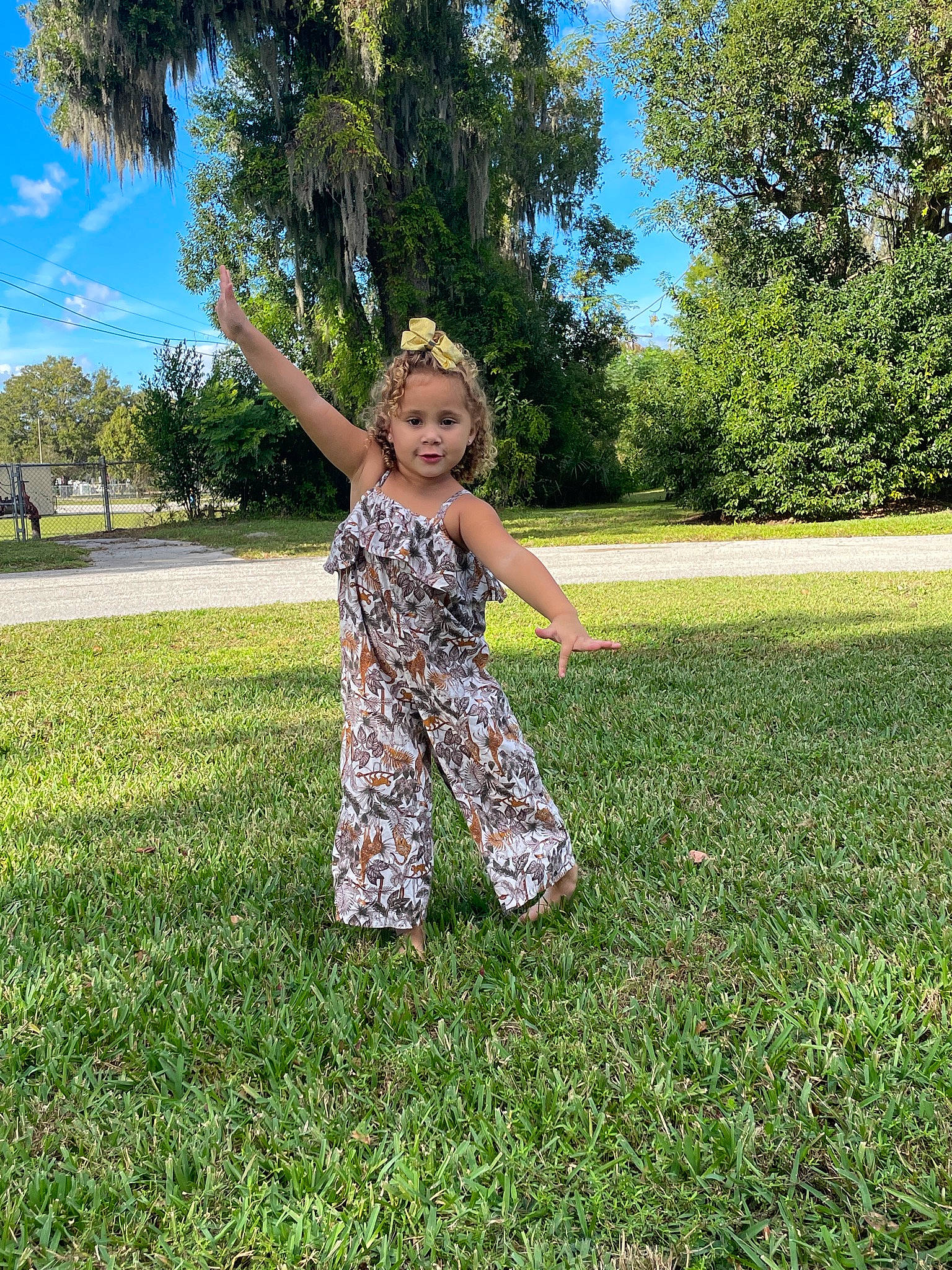 Julianna is registered to the contest to win money with this photo: day_dress, field, fun, gesture, grass, grassland, happy, landscape, lawn, leisure, meadow, nature, pasture, people_in_nature, person, plant, prairie, sky, summer, tree