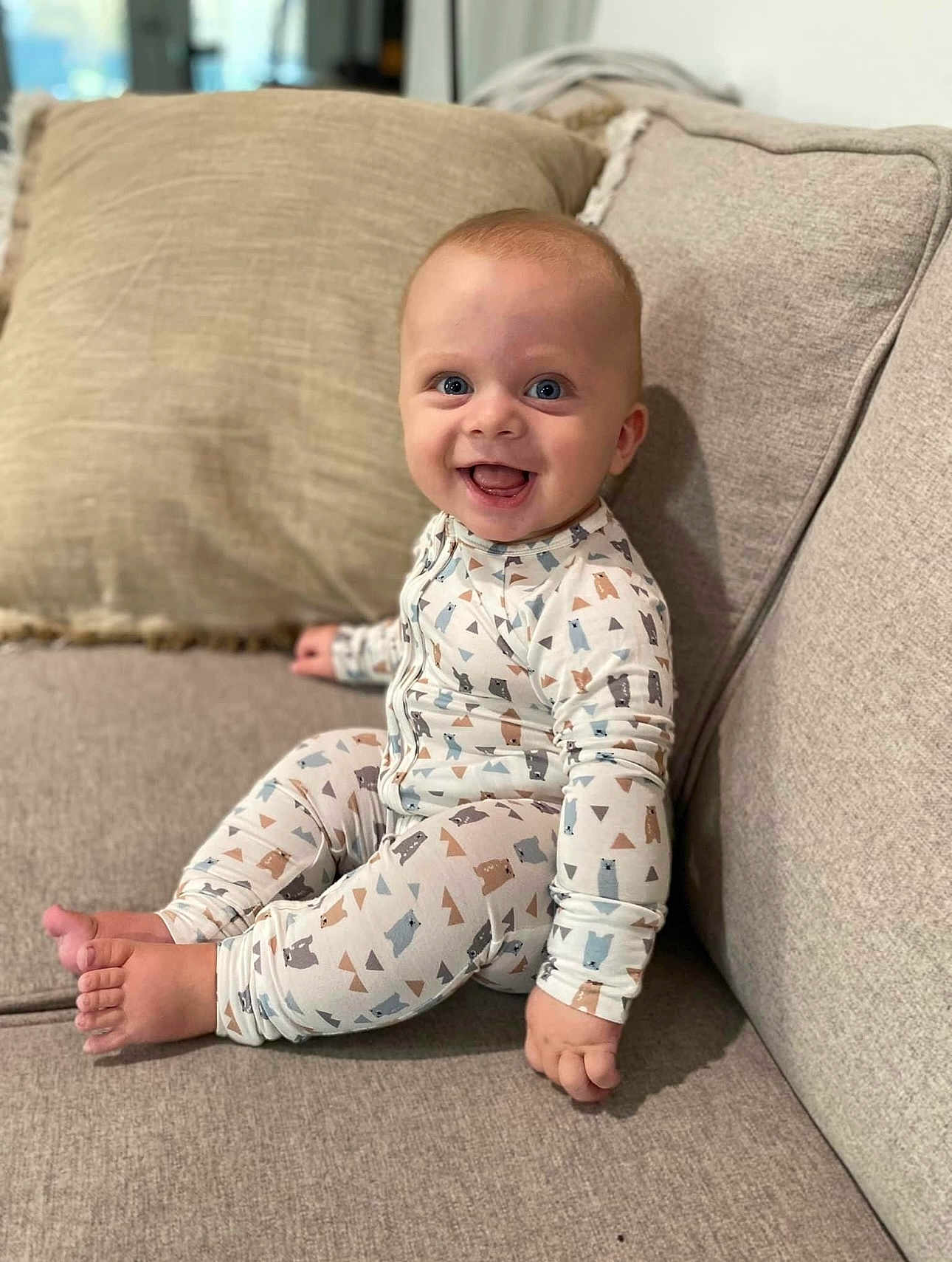 Elijah joined the competition — help win amazing prizes! baby, babylaughing, clothing, cushion, face, happy, head, homedecor, pajamas, pants, person, photography, portrait, sitting, sleeve, smile