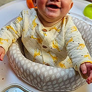Hayde is registered to the contest to win money with this photo: baby, infant, smile, giraffe_pattern, baby_walker, child, happy, cute, indoor, clothing, seat, playtime, person, young_child, joyful, portrait, sitting, head, face, expression