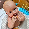baby, child, food, eating, highchair, hands, face, skin, toy, indoor, cushion, seat, curious, munching, closeup, person, furniture, wood, play, infant