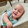 baby, infant, smile, happy, child, toy, seated, indoor, closeup, face, skin, hand, clothing, baby_seat, playtime, cute, young, expression, person, home